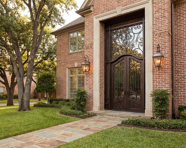 Please create an image of a high end iron front door on a traditional home that .jpeg